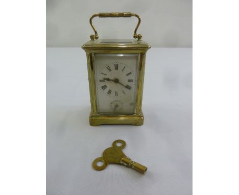 Brass carriage clock of customary form with key