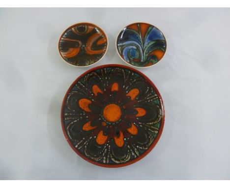 Three Poole Pottery decorative plates, marks to the base