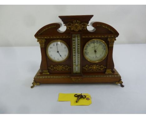 A late 19th century Victorian mahogany cased desk clock, Barometer and Thermometer with gilt metal decoration and paw feet