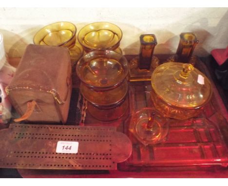 A Tray Containing Amber Glass Ware, Brass Cribbage Board, Camera and Bible.