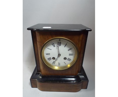 An Ebonised and Walnut Mantle Clock.