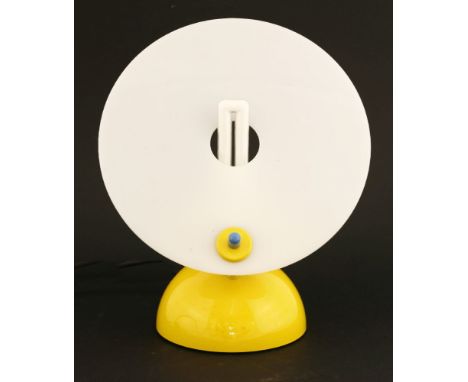 A Memphis-style table lamp,with a glass disc shade, raised on a yellow dome base,26.5cm high