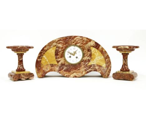 An Art Deco 'bat wing' rouge marble clock garniture, with an enamelled and garlanded dial, 44cm wide 25cm high garnitures 19c