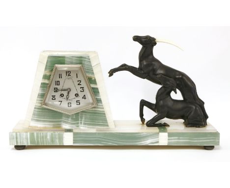 An Art Deco bicolour mantel clock, mounted with two mountain ibex, one lacking horns, the dial inscribed 'A. Ploquet Valognes