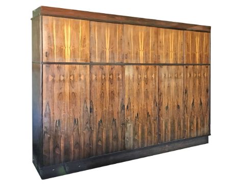 A Danish rosewood wardrobe,with an arrangement of cupboards,310cm wide64cm deep250cm high