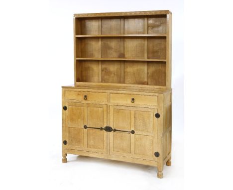 A Robert 'Mouseman' Thompson oak dresser,c.1977, with an arcaded cornice over shelves, two drawers and a cupboard, 122cm wide