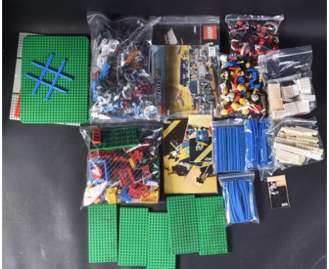 A large collection of assorted loose Lego bricks, minifigures and instruction manuals. Largely vintage pieces to include 1970