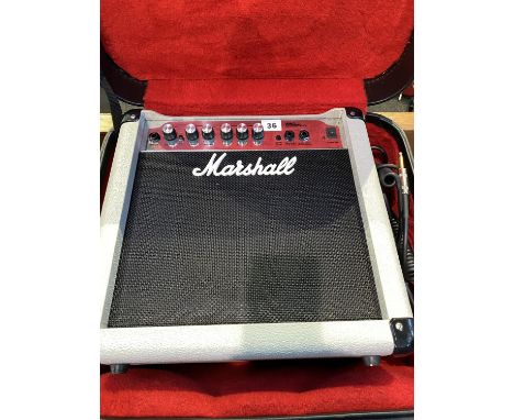 A cased Marshall MG15CD guitar amp