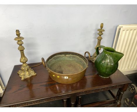 A Victorian copper braising pan, diameter 43cm, a pair of brass Rococo style lamp bases and a green glazed pitcher
