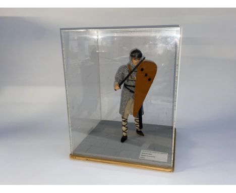 Three cased museum displays of costume doll figure groups, labelled for Doncaster Museums Service and depicting Norman Soldie