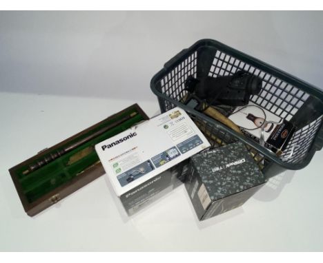 A basket of fishing accessories, including priests, scales, monocular and other items