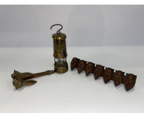 A Hockley Lamp and Lighting Company brass cased miner's lamp, 22cm H, a vintage brass anchor by WL Byers and Co., and a carve