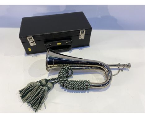 A cased chromed metal bugle, with case
