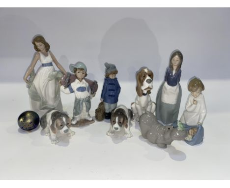 A selection of Lladro and Nao porcelain figural studies, the largest measures 28cm H and an iridescent Royal Brierley glass p