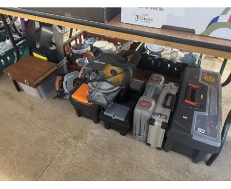 A collection of mixed tools in tool boxes including saws