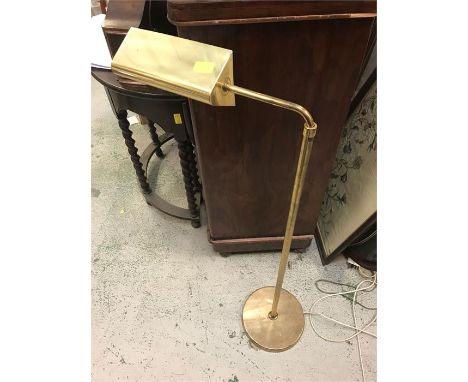 A brass telescopic reading lamp