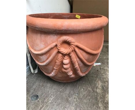 A pair of terracotta garden planters with sash style design.