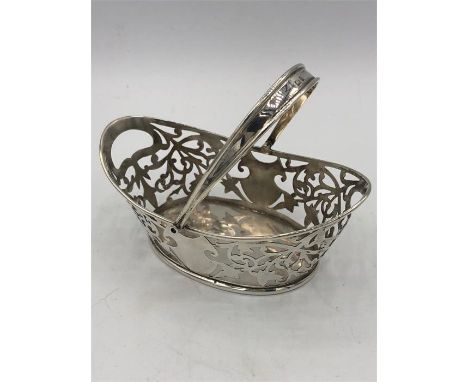 A silver hallmarked basket with handle, makers mark M + C.
