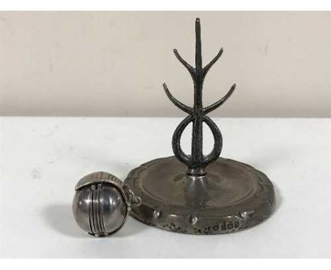 An unusual silver fob, together with a silver ring stand 