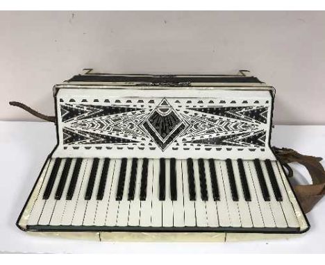 A accordion by Geraldo in a carry bag 