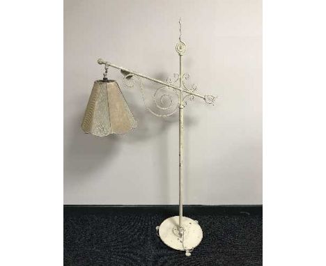 An early 20th century wrought iron adjustable standard lamp 