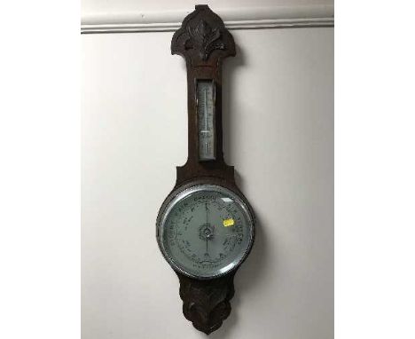 A carved oak aneroid barometer 