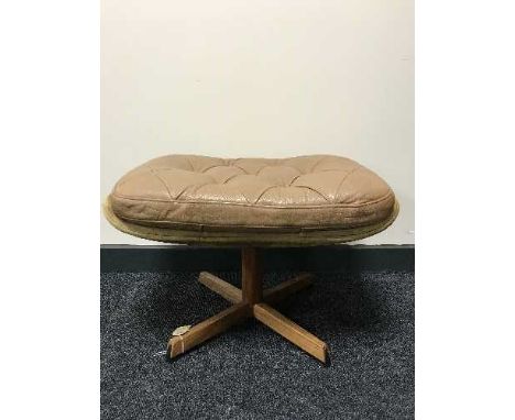 A mid 20th century button leather swivel footstool on a rosewood base 