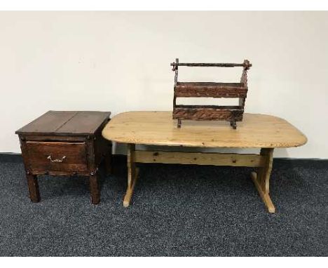 An oval pine coffee table, mag rack and a rustic pine lamp table 