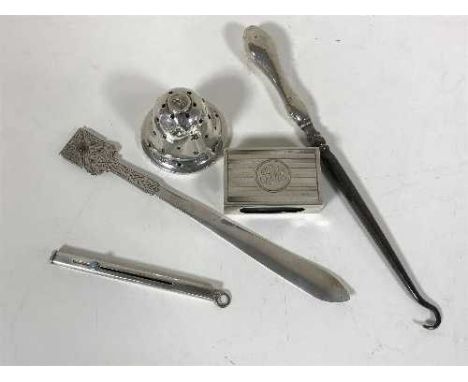 A group of silver to include a matchbox holder, pin-stand, button hook etc (5)