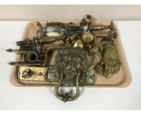 A tray of brass taps, brass door knocker, door furniture etc 