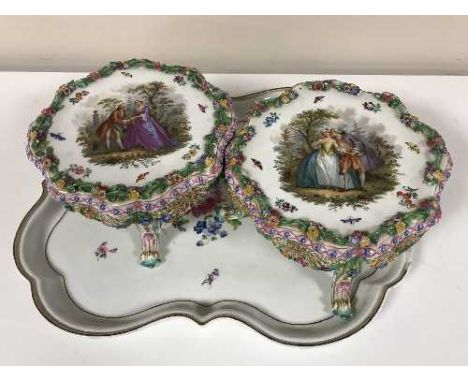 A pair of Meissen porcelain table stands painted with lovers in a garden, together with a shaped continental hand-painted tra