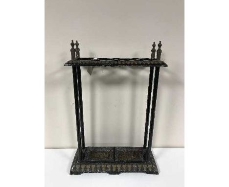 An antique cast metal stick stand with stick trays 