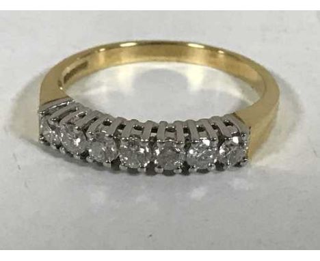 An 18ct gold seven stone diamond ring