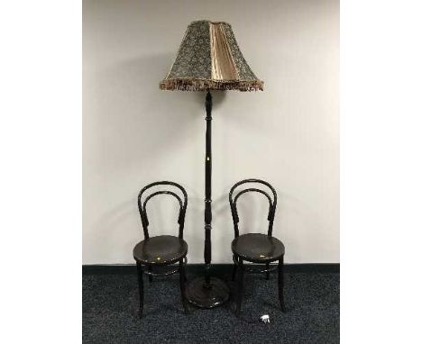 A standard lamp with shade and a pair of Bentwood chairs 