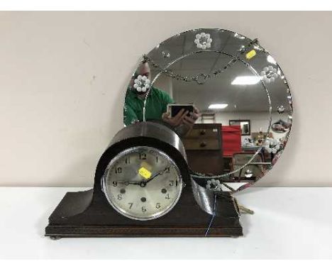 An oak cased mantel clock with silvered dial and an un-framed circular mirror 
