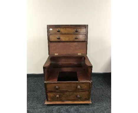 A mahogany commode in the form of a chest 