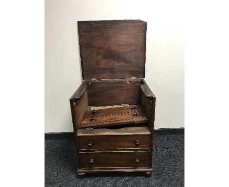 A mahogany commode in the form of a chest 