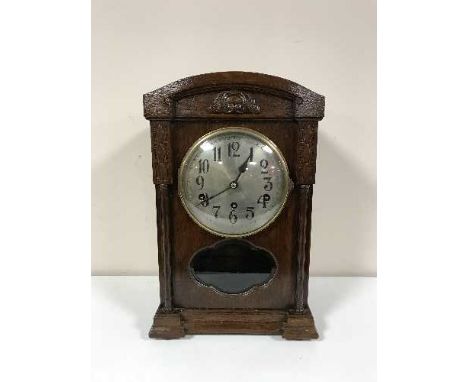 An oak bracket clock with silvered dial 