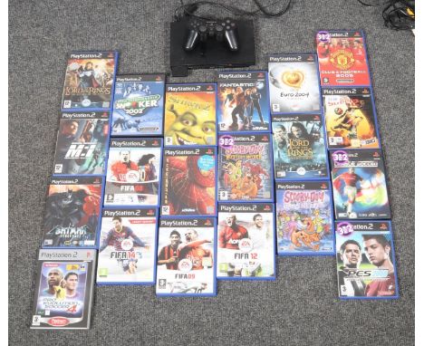 A playstation 2 console with a quantity of games and controller.  