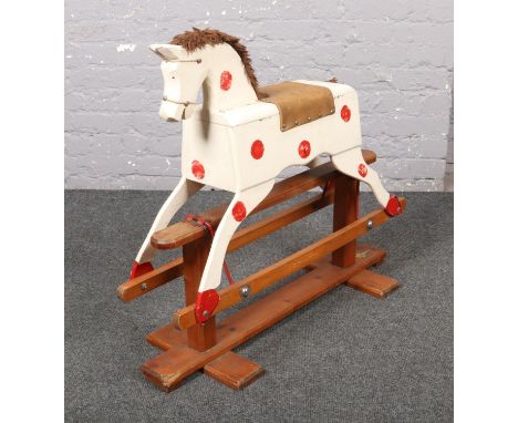 A vintage white painted wooden rocking horse by Leeway.  