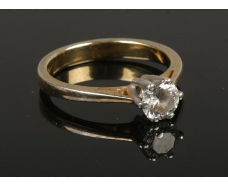 A silver ring set with a single cubic zirconia stone, size P.  