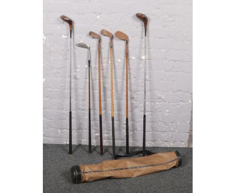 A golf bag and selection of vintage golf clubs, to include hickory shaft examples, Aitken, Gibson etc.  