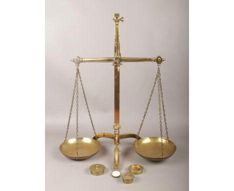 A set of Vandome &amp; Co brass balance scales, with three Sovereign weights.  One weight says 50 sovereign and the other two