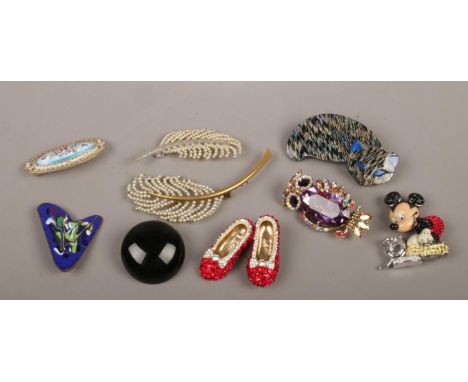 A box of costume jewellery brooches including Butler &amp; Wilson owl and ruby slippers etc.  