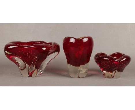 A Whitefriars glass ruby red molar vase with controlled bubble pattern by Geoffrey Baxter along with two Whitfriars ruby red 