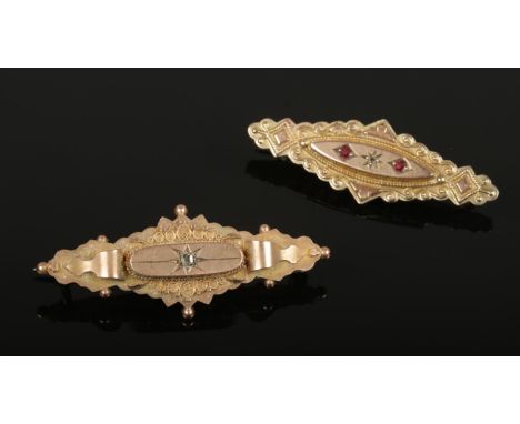 A 9ct gold diamond and ruby lozenge shape brooch along with another 9ct gold and diamond brooch.  