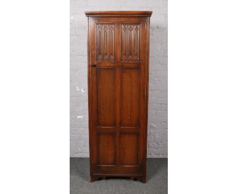 A carved and panelled oak hall robe. Fitted with one shelf inside, 179cm high, 65cm wide, 45cm deep.  