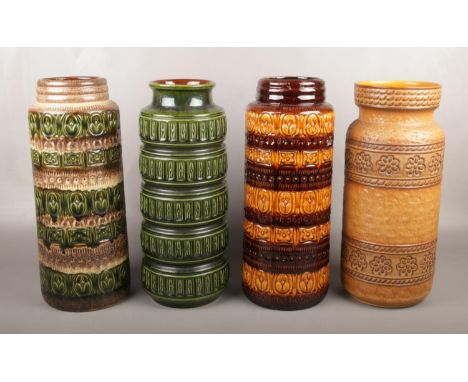 Four large West German pottery stick stands. (Height 42cm).  