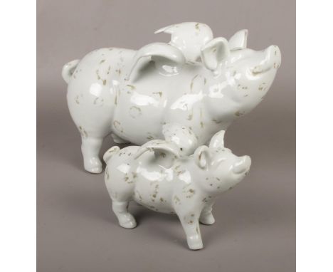 Two ceramic winged pigs  