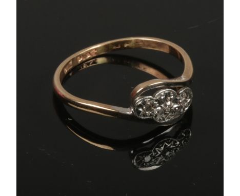 A 9ct gold and platinum three stone diamond ring. c.1950, size R.  